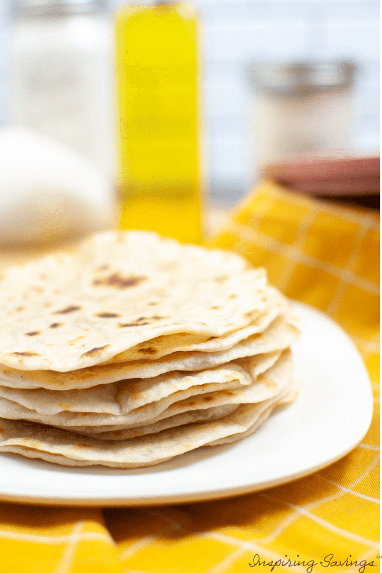 Easy Homemade Corn Tortillas - homemade tortillas stacked on white plate